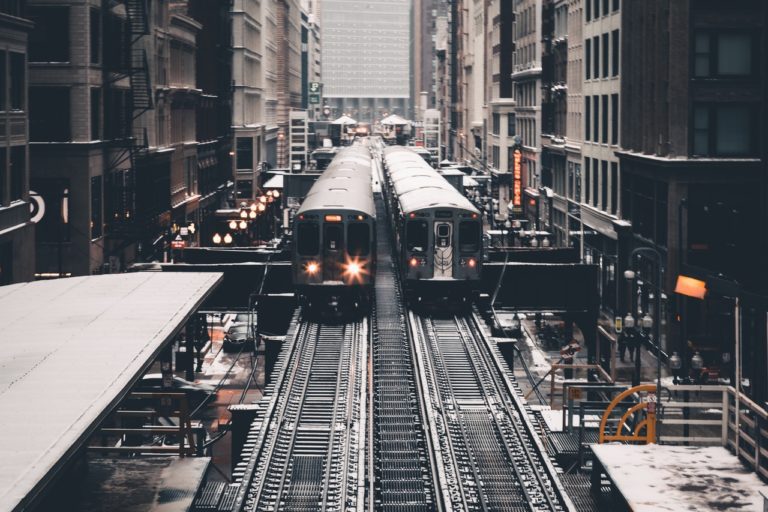 A train is on the tracks in a city.